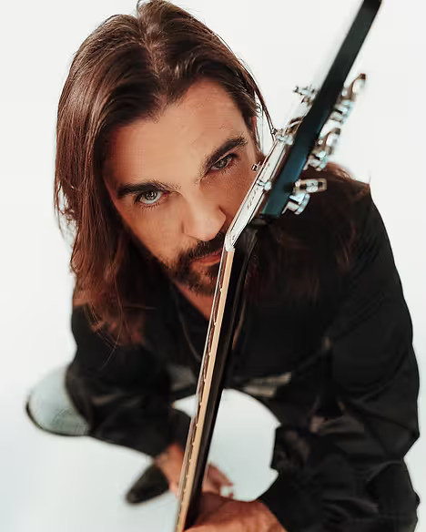 Close up of musician holding a guitar