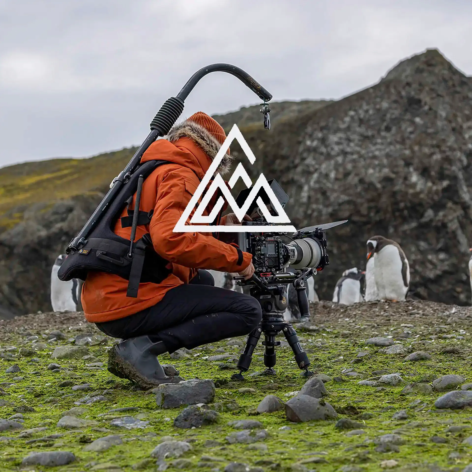 Professional RED camera equipment being set up in Antarctica for a video shoot. Canwell Media Icon in white.