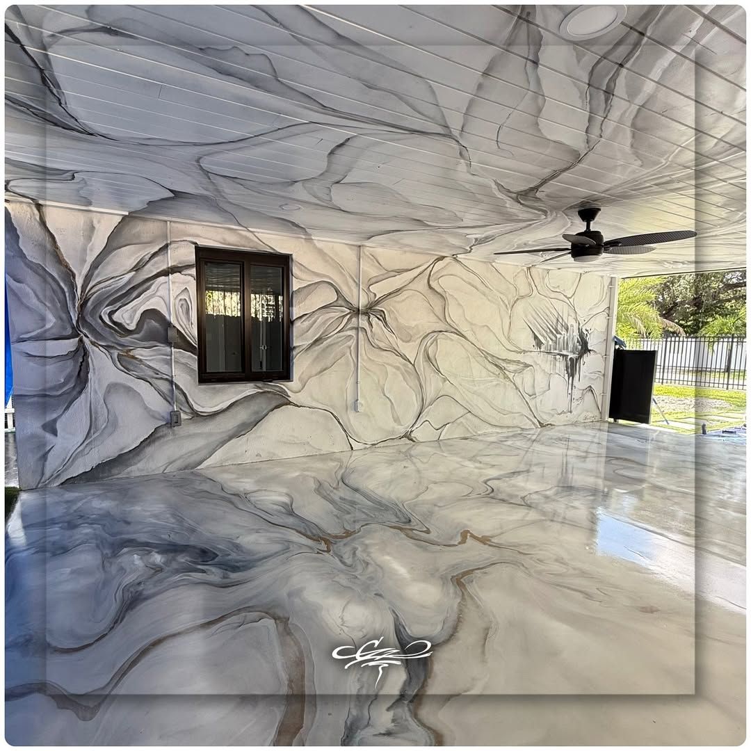 An immersive custom mural with a grey and white marble effect covering the walls, ceiling, and glossy floor of a garage.